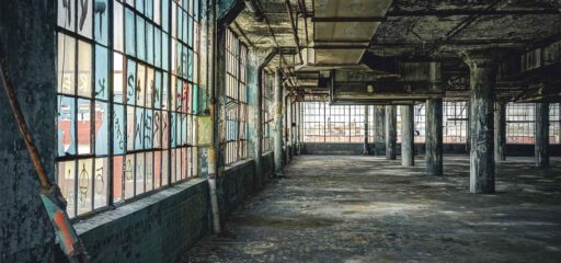 How environmental Justice impoverishes the poor - shows an abandoned automotive plant in Detroit Michigan.